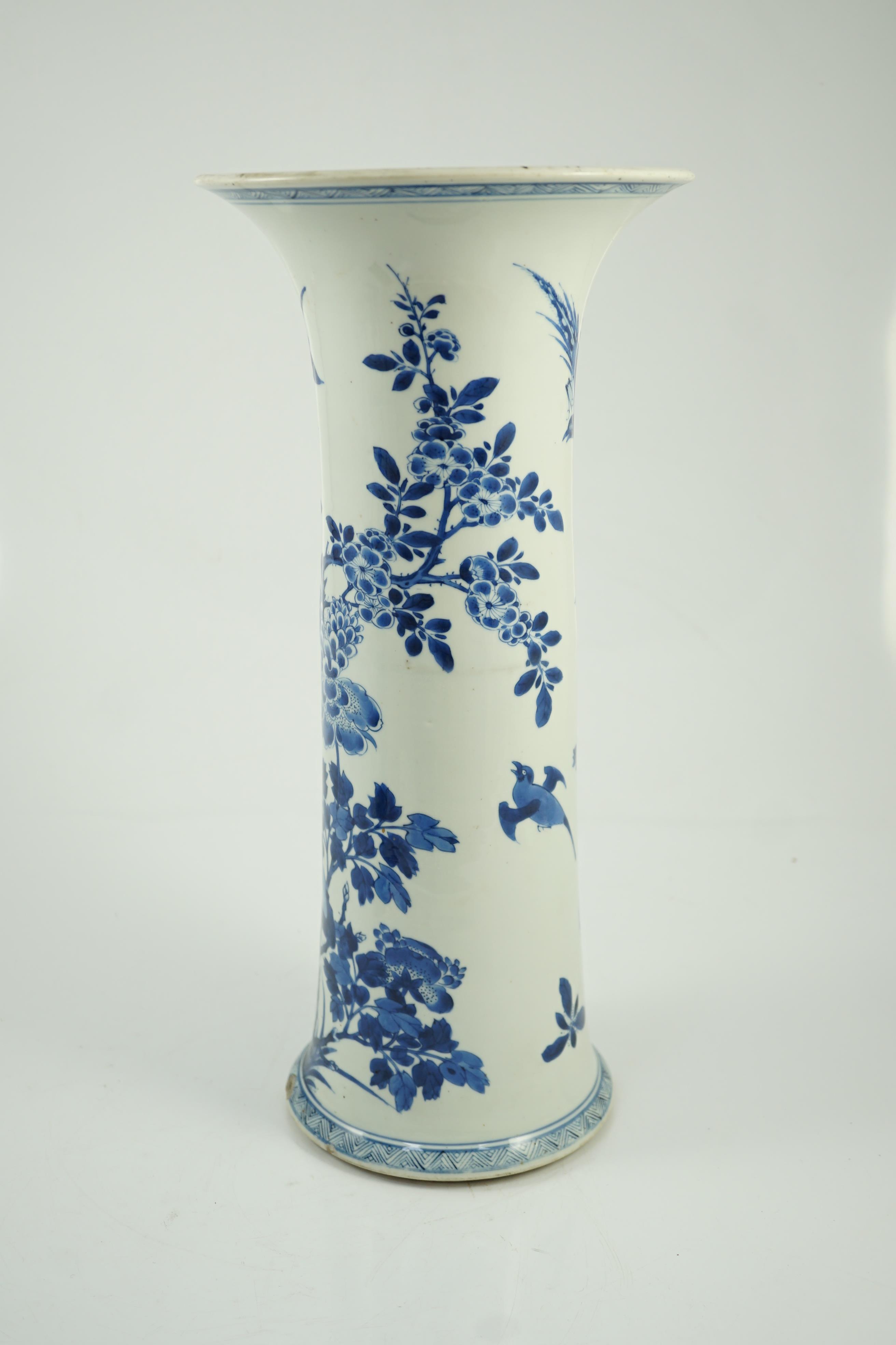 A tall Chinese blue and white ‘pheasants and rocks’ beaker vase, gu, Kangxi period, minor faults